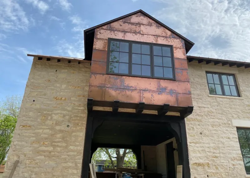 Copper metal panel facade on a stone building for Metal Roof Coating in Upper Arlington